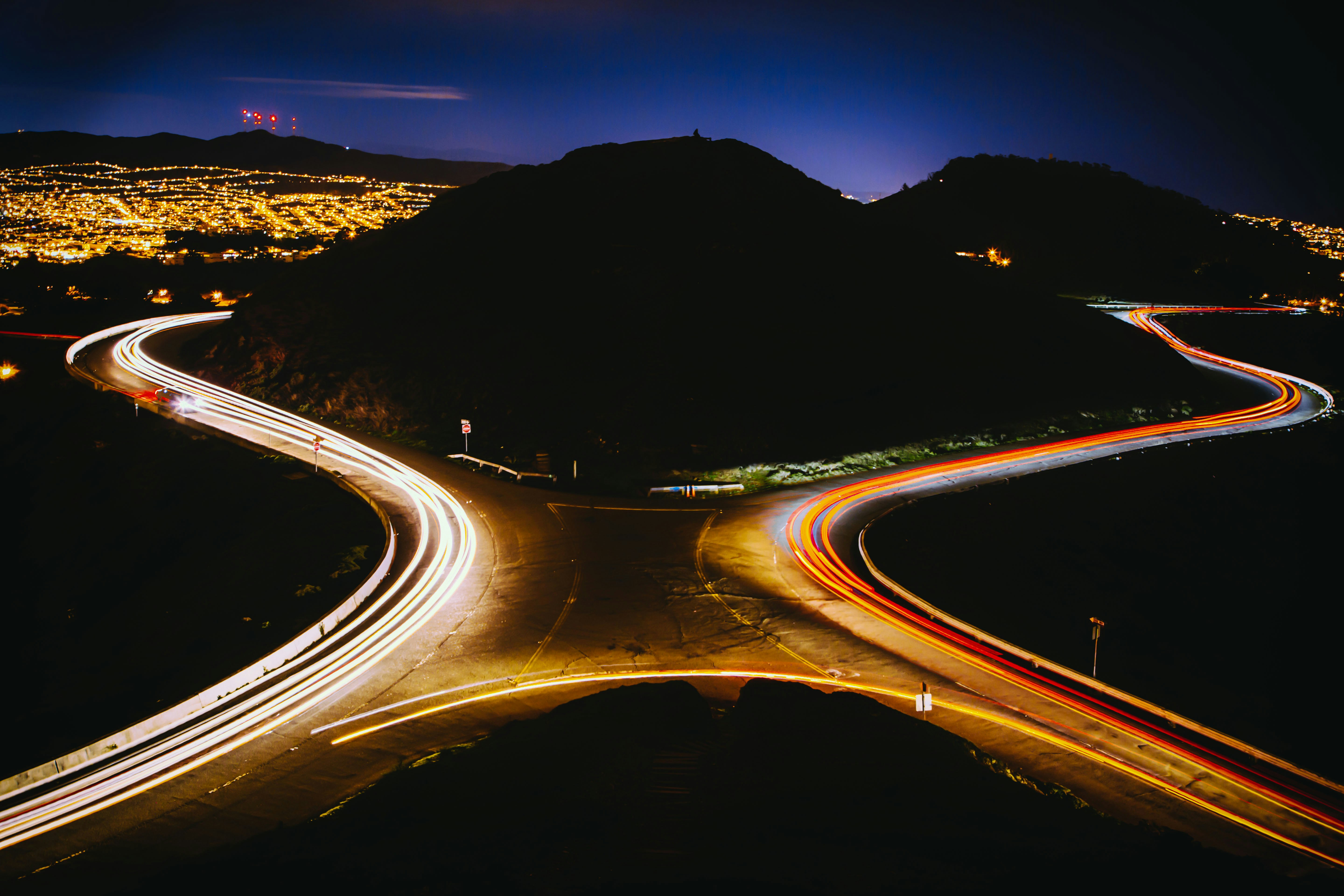 aerial view photography of cross road near mountain during nighttime